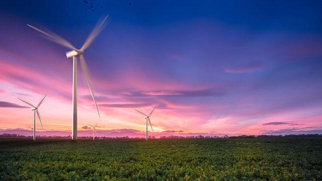 Three wind turbines on a green landscape